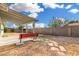 Landscaped backyard featuring a concrete patio, red bench, a concrete block fence, and gravel groundcover at 17616 N 20Th Dr, Phoenix, AZ 85023