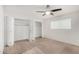 Spacious bedroom with plush carpet, a modern ceiling fan and ample closet space at 17616 N 20Th Dr, Phoenix, AZ 85023