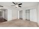 Bright bedroom with carpet, a ceiling fan, access to ensuite and plenty of closet space at 17616 N 20Th Dr, Phoenix, AZ 85023