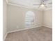 This bedroom features carpet floors, an arched window, crown molding and a ceiling fan at 17616 N 20Th Dr, Phoenix, AZ 85023