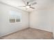 This bedroom has a ceiling fan, carpet floors, and a window with blinds for natural light at 17616 N 20Th Dr, Phoenix, AZ 85023