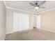 This bedroom features carpet floors, a ceiling fan, and a double door closet at 17616 N 20Th Dr, Phoenix, AZ 85023