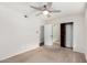 This bedroom features carpet flooring, a ceiling fan, a closet with mirrored doors and wood trim at 17616 N 20Th Dr, Phoenix, AZ 85023