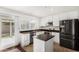 Modern kitchen featuring stainless appliances, white cabinetry, and a convenient center island at 17616 N 20Th Dr, Phoenix, AZ 85023