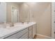 Bathroom featuring double sink vanity with neutral tone cabinets and quartz countertops at 1895 N 141St Ave, Goodyear, AZ 85395