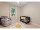 Bedroom with chair, crib, sunshine rug, and window for natural light at 1895 N 141St Ave, Goodyear, AZ 85395