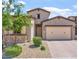 Charming single-Gathering home with stone accents, desert landscaping, and a two-car garage at 1895 N 141St Ave, Goodyear, AZ 85395