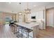 Open-concept kitchen with island seating, stainless steel appliances, and access to dining area at 1895 N 141St Ave, Goodyear, AZ 85395