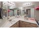 Bathroom with double sinks and a large mirror, featuring updated lighting fixtures and decor for a modern feel at 20440 N 39Th Dr, Glendale, AZ 85308