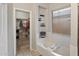 Bathroom featuring a soaking tub with window and niches, with a door to walk-in closet at 20440 N 39Th Dr, Glendale, AZ 85308