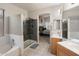 Bright bathroom features a tiled shower, separate tub, and double sinks with views into the spacious primary bedroom at 20440 N 39Th Dr, Glendale, AZ 85308
