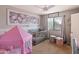 Charming bedroom with a crib, floral decor, and a cozy atmosphere, perfect for a Bedroom at 20440 N 39Th Dr, Glendale, AZ 85308