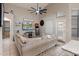 Cozy living room featuring a ceiling fan, backyard access, neutral tones, and comfortable furniture at 20440 N 39Th Dr, Glendale, AZ 85308