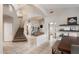Open-concept living space with staircase, dining area, and living room, featuring tile floors and neutral tones at 20440 N 39Th Dr, Glendale, AZ 85308