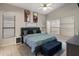 Vaulted ceiling primary bedroom boasts blue accents, neutral tile floors, and bright windows for natural light at 20440 N 39Th Dr, Glendale, AZ 85308