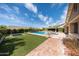 Expansive backyard features a swimming pool, well-manicured lawn, and a covered patio for entertaining at 20585 W Garden St, Buckeye, AZ 85396