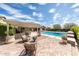 Outdoor patio space featuring a fire pit, dining and conversation seating with a view of the pool at 20585 W Garden St, Buckeye, AZ 85396