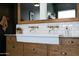 Stylish bathroom vanity with double faucets, marble countertops, and wooden cabinetry at 20585 W Garden St, Buckeye, AZ 85396