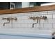 Close-up of a farmhouse sink with chrome faucets and subway tile backsplash at 20585 W Garden St, Buckeye, AZ 85396