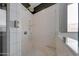 A tiled shower with a glass door, rainfall showerhead, and a built-in bench at 20585 W Garden St, Buckeye, AZ 85396