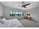 Bright bedroom with large windows overlooking a backyard pool and landscaping, offering a serene and relaxing retreat at 20585 W Garden St, Buckeye, AZ 85396