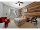 Stylish bedroom with a wood accent wall and modern furnishings at 20585 W Garden St, Buckeye, AZ 85396