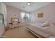 Cozy bedroom featuring a bed, desk and chair with natural light at 20585 W Garden St, Buckeye, AZ 85396