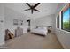 Spacious primary bedroom with a cozy sitting area, ensuite bathroom access, and large windows providing natural light at 20585 W Garden St, Buckeye, AZ 85396