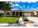 Charming single-Gathering home featuring a well-manicured lawn, a covered porch, and an attached two-car garage at 20585 W Garden St, Buckeye, AZ 85396