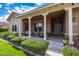 Inviting front porch with swing, seating, and lush landscaping at 20585 W Garden St, Buckeye, AZ 85396