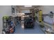 Organized garage with ample storage, work bench, golf cart, and bike racks for convenient parking and hobbies at 20585 W Garden St, Buckeye, AZ 85396