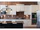 Modern kitchen with an island featuring granite countertops and stainless steel appliances at 20585 W Garden St, Buckeye, AZ 85396