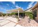 Outdoor patio area with dining table, grill, comfortable seating and lush greenery, perfect for entertaining at 20585 W Garden St, Buckeye, AZ 85396