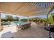 Outdoor patio space with dining area, built-in grill, and a view of the sparkling pool at 20585 W Garden St, Buckeye, AZ 85396