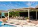 Beautiful backyard pool area features covered dining, barbecue, and a basketball hoop for outdoor fun at 20585 W Garden St, Buckeye, AZ 85396