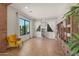 Bright sitting room featuring large windows, a cozy chair, and a bookshelf, creating a perfect reading space at 20585 W Garden St, Buckeye, AZ 85396