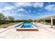 Backyard showcasing a large swimming pool, spa, lush landscaping, and outdoor dining area at 20585 W Garden St, Buckeye, AZ 85396