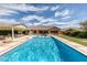 Full-length pool featuring water features, surrounding lounge area, and beautifully landscaped greenery at 20585 W Garden St, Buckeye, AZ 85396