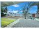 Backyard featuring stone landscaping, artificial turf and seating area under the tree at 2127 W San Miguel Ave, Phoenix, AZ 85015