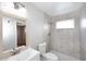 Bathroom featuring shower stall with gray tiling, toilet, and a single sink vanity at 2127 W San Miguel Ave, Phoenix, AZ 85015