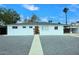 Inviting single-story home with white exterior, complemented by a well-maintained landscape at 2127 W San Miguel Ave, Phoenix, AZ 85015