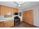 Well-lit kitchen with stainless steel oven and microwave, light wood cabinetry and ceramic tile flooring at 2127 W San Miguel Ave, Phoenix, AZ 85015
