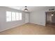 Bright living area featuring hardwood floors, plantation shutters, and a stylish light fixture at 2127 W San Miguel Ave, Phoenix, AZ 85015