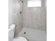 A tile shower stall with shower head, window, and tiled floor in the bathroom at 2127 W San Miguel Ave, Phoenix, AZ 85015