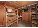 Spacious storage room with open shelving, plywood walls, and concrete floor at 2127 W San Miguel Ave, Phoenix, AZ 85015