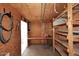 Versatile storage area with built-in shelving, workbench, plywood walls, and easy access to the outdoors at 2127 W San Miguel Ave, Phoenix, AZ 85015