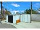 Two storage sheds in backyard offering ample outdoor storage space, set against a blue sky at 2127 W San Miguel Ave, Phoenix, AZ 85015