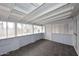 This sunroom features walls of windows, ceiling beams and a tile floor at 2127 W San Miguel Ave, Phoenix, AZ 85015
