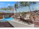 Backyard boasts a spa pool, dining set, lush desert plants, and a charming mural at 2328 W Calle Marita --, Phoenix, AZ 85085