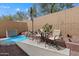 Backyard boasts a spa pool, dining set, lush desert plants, and a block fencing at 2328 W Calle Marita --, Phoenix, AZ 85085